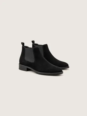 AI-generated product photo of the black suede chelsea boots, one of the pieces in the Someone Shop.
